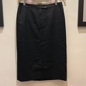 Wool calf length black skirt with front slit. Size 10. Looks great with boots.